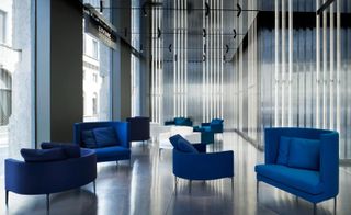 Living Divani Gallery in Milan with bright blue armchairs
