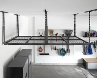 a garage roof with ceiling storage rack, with wall storage full of yard essentials
