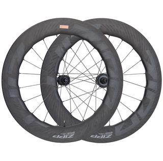 A pair of Zipp 858 NSW wheels sit on a white background