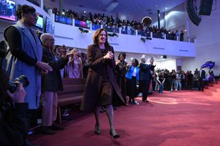 Kamala Harris attends a church service wearing a brown dress and a brown coat