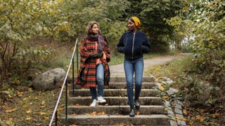 Two women walking in park and talking