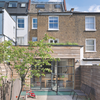 Rear garden at Susanna and Michaelis home, looking into the kitchen extension. A Victorian terraced house in West London, family home of Helene de Witte and Nicolas Tjandramaga and their children