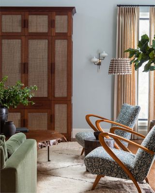 mid-century modern armchairs with Berber rug and rattan cabinet
