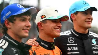 McLaren's Lando Norris standing with Mercedes duo Kimi Antonelli and George Russell at Interlagos ahead of the 2025 Brazilian Grand Prix