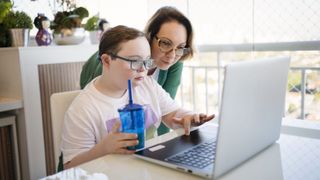 Is it still worth getting an online tutor: Image shows young child and mother looking at computer screen