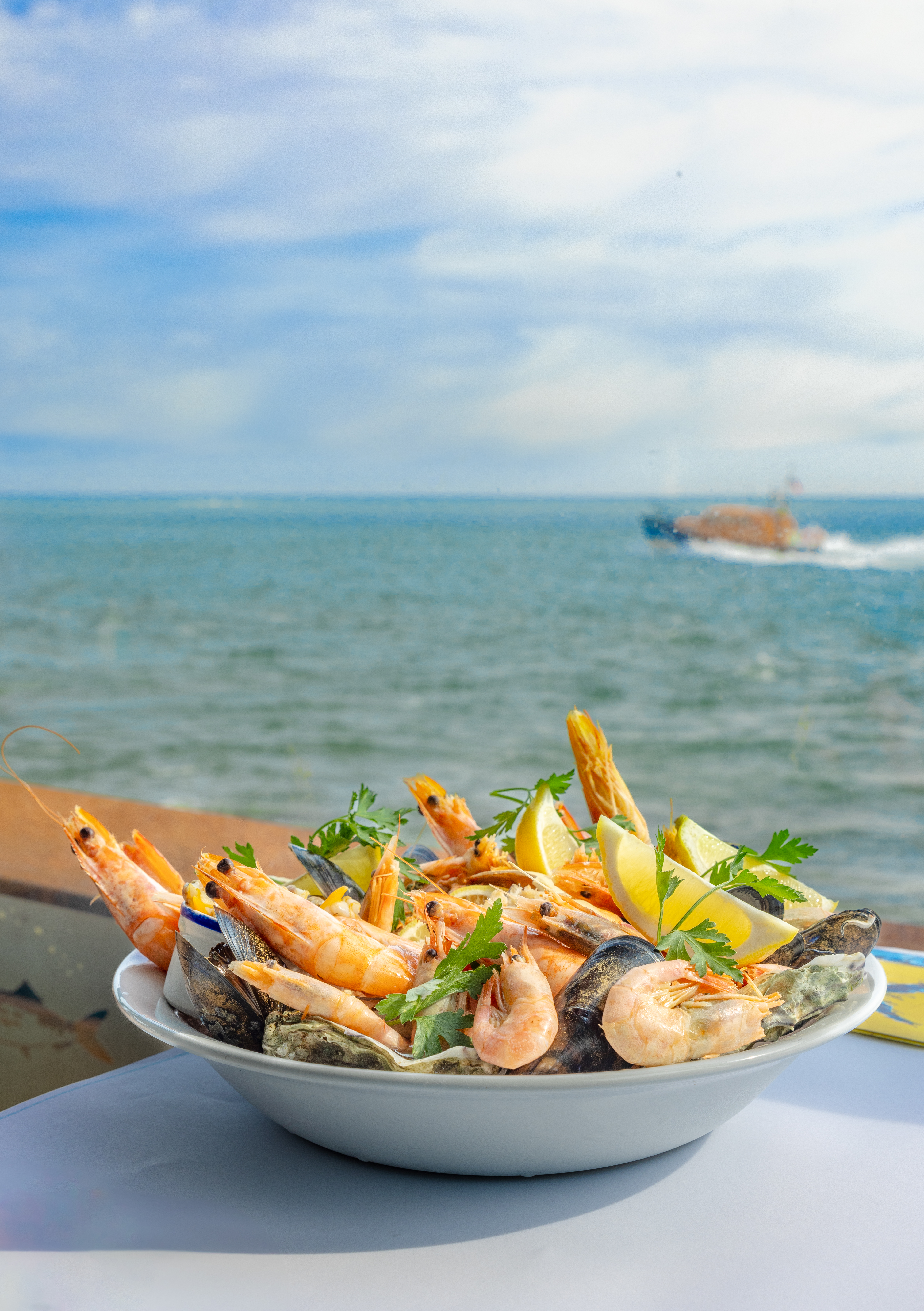 Bowl of prawns with the sea in the background