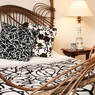 Bedroom with a wood frame bed and black and white bedding