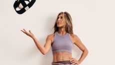 Jennifer Aniston tosses a Pilates ball in the air