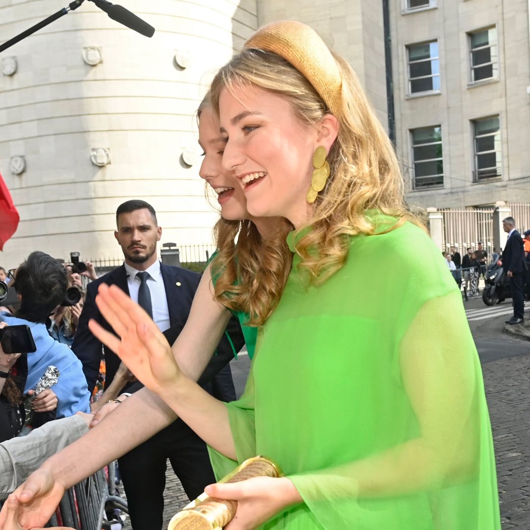 Princess Elisabeth in a green dress greeting fans on National Day