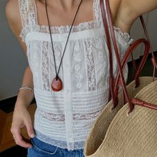 Woman in white lace embroidered summer top