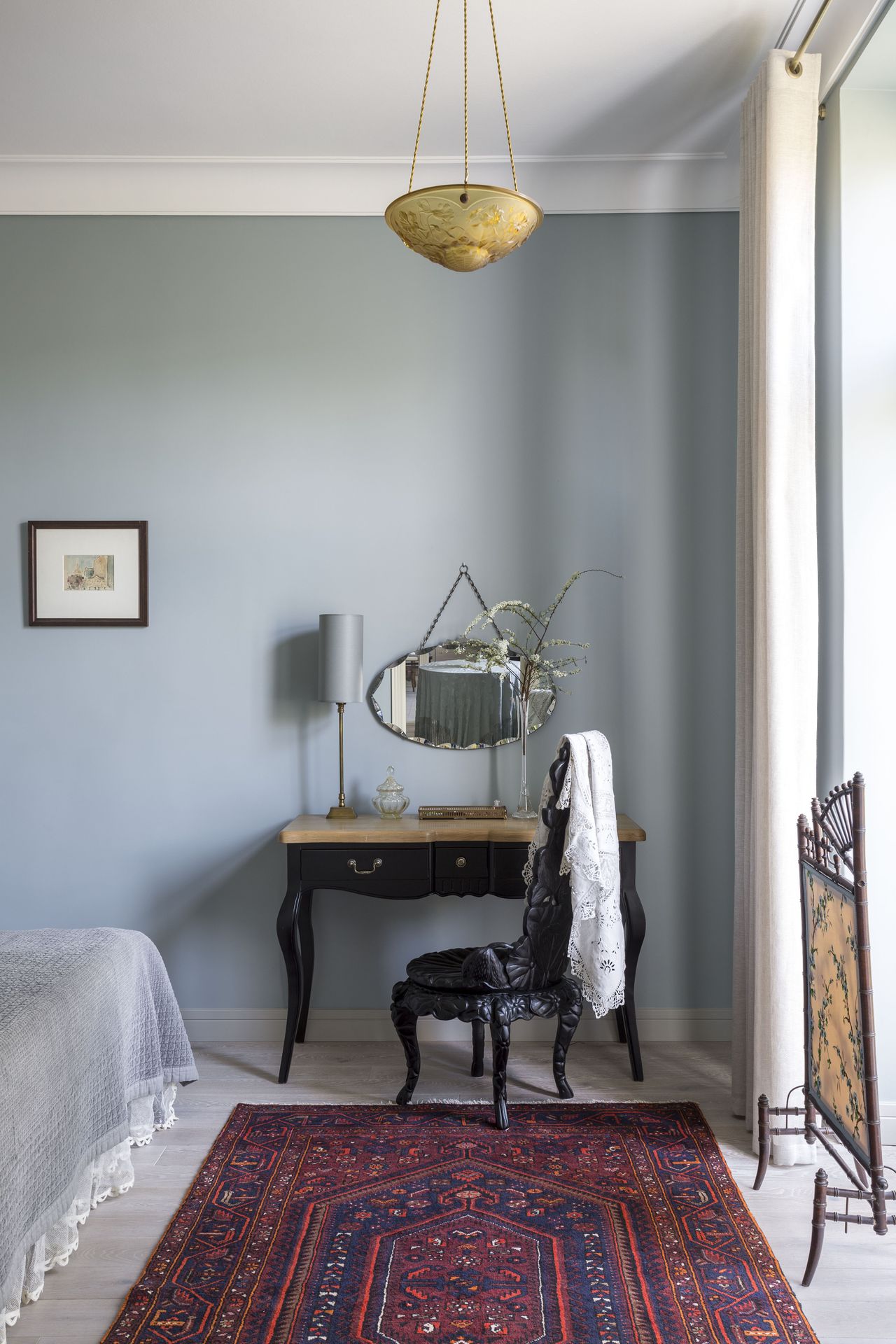 A red printed rug inside a muted bedroom