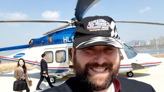 Philip Berne boarding the Samsung helicopter wearing a Samsung Mobile 500 hat