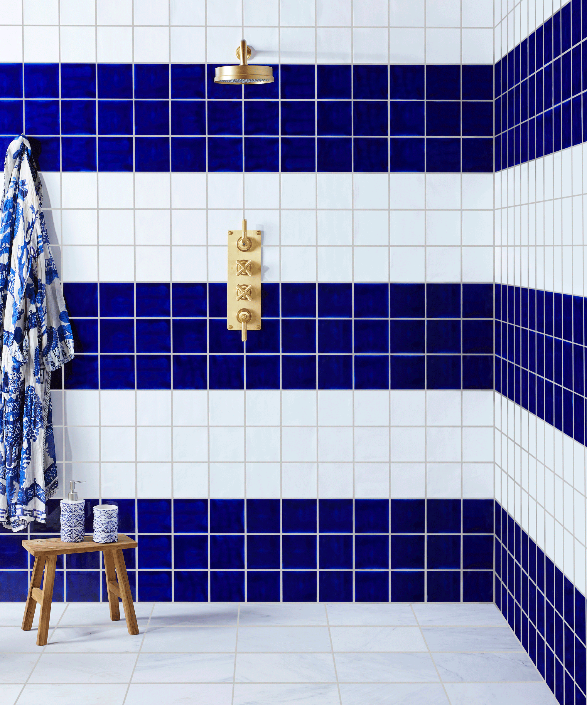 Bathroom shower tiled in blue and white squared tiles