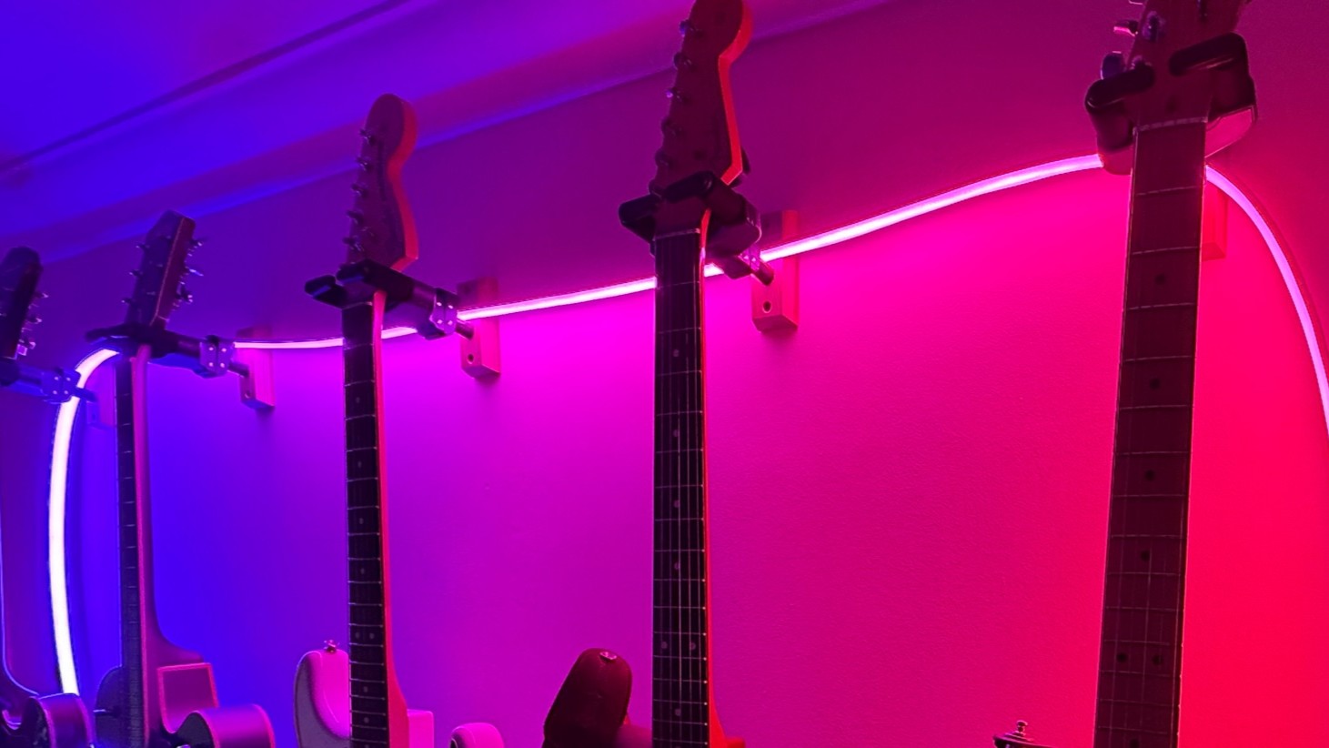 Philips Hue Omniglow lightstrip behind guitars