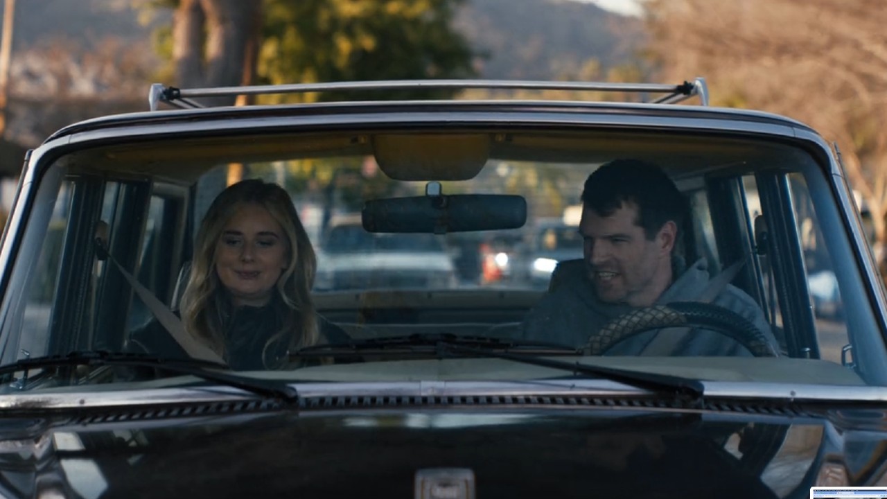 From left to right; Morgan and Sasha sitting in his car in Nobody Wants This.