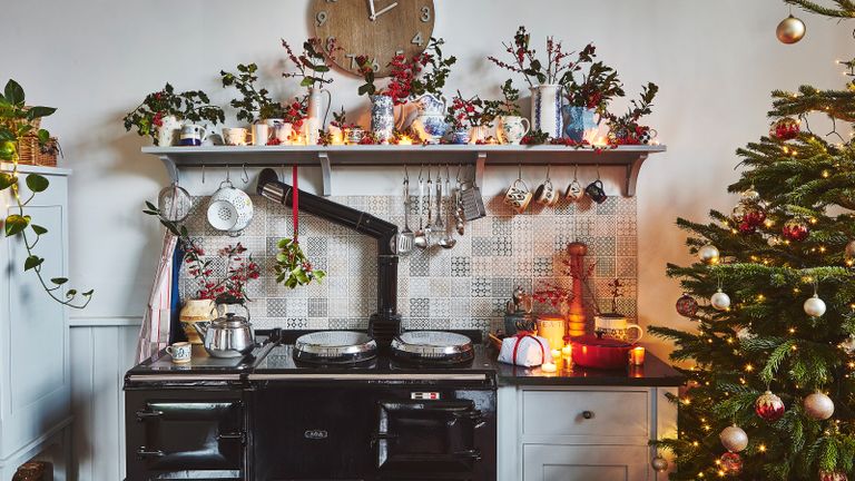 kitchen with black aga and open shelf decorated for Christmas