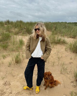 Woman in barn jacket and jeans.