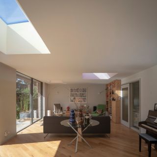 Subtle paint colours in the rooflight openings shift in tone throughout the day