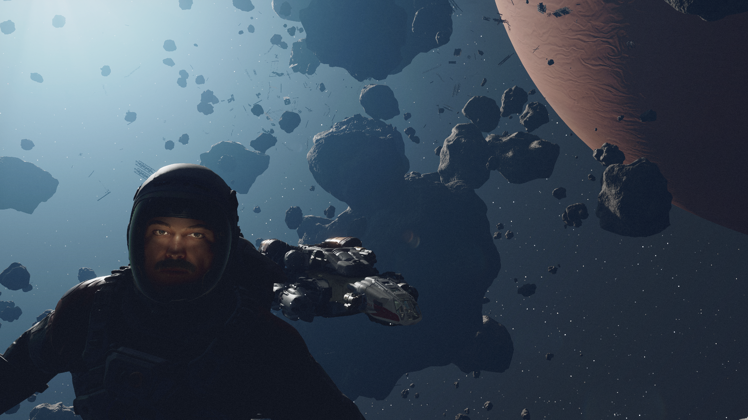 Starfield character in space suit floating amid asteroid field above gas giant