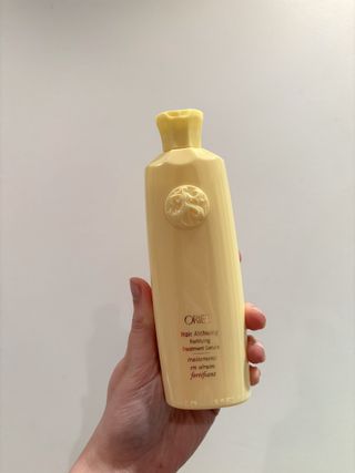 Mica Ricketts holding Oribe Hair Alchemy Fortifying Treatment Serum