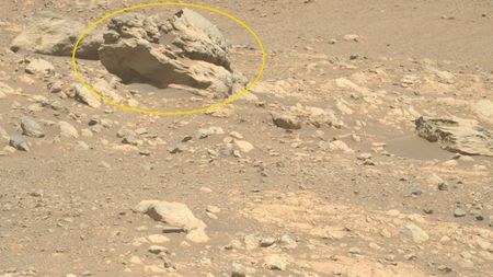 A photo of a large boulder-like rock on Mars, circled by a yellow ring annotation