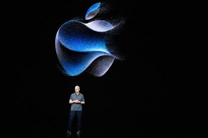 Apple CEO Tim Cook in front of digitized Apple logo