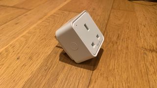 WiZ Smart Plug on a wooden floor