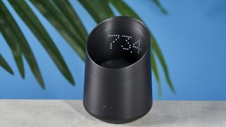 a black plastic coffee doser with an aesthetically pleasing design and a curved built-in LED screen