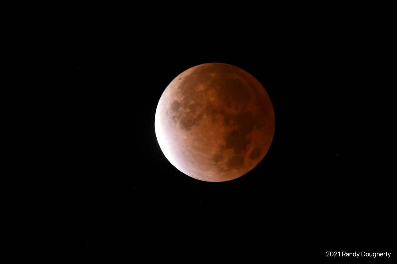 Astrophotographer Randy Dougherty snapped this photo of the Beaver Moon partial lunar eclipse as it shined over Lake Michigan near Ludington, Michigan on Nov. 19, 2021. I was lucky to have the heavy cloud cover intermittently clear so I could get some photos."