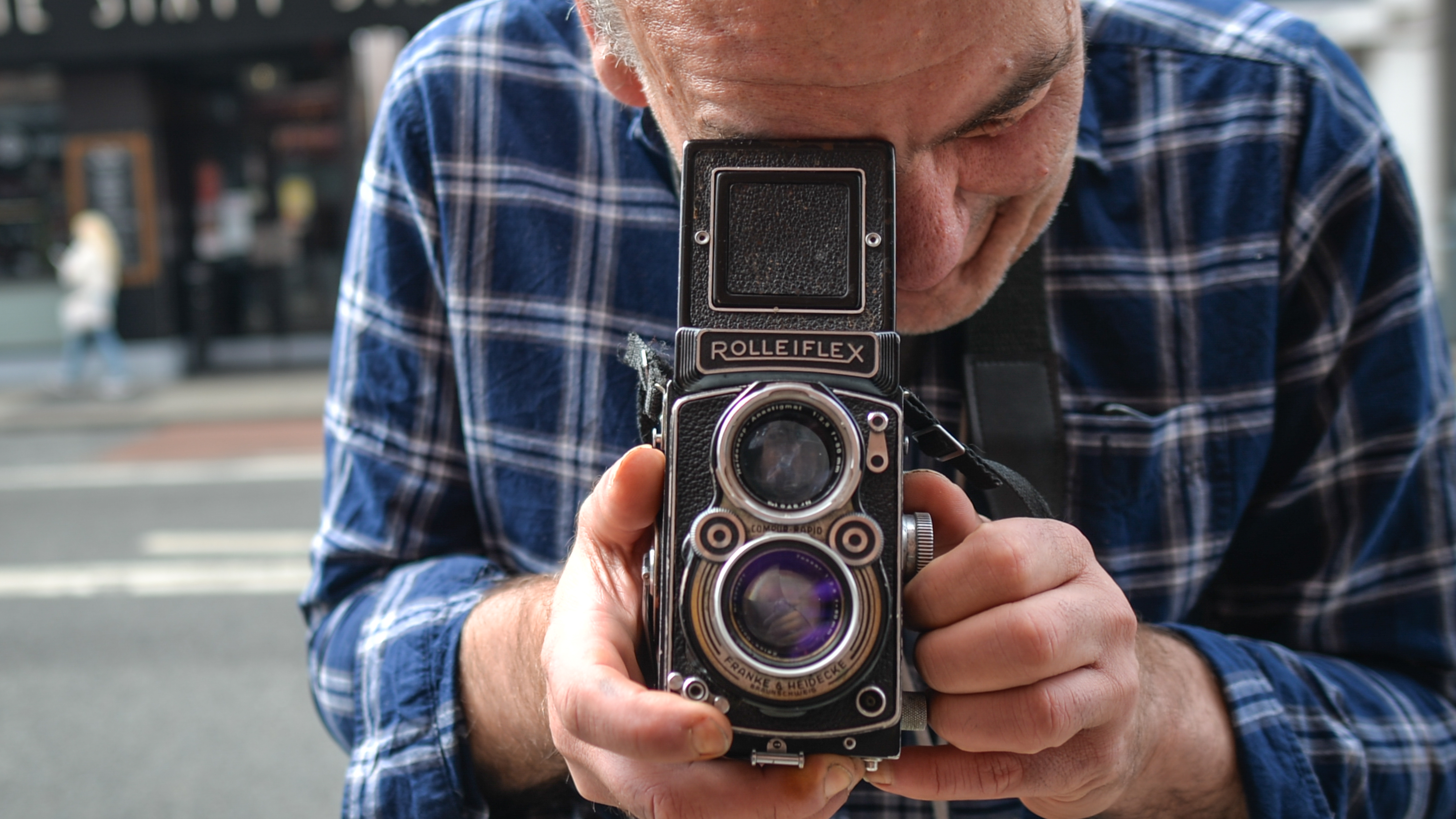 A photographer uses a Rolleiflex camera