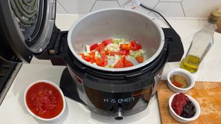 Onions and peppers being sauted in the Ninja Foodi 11-in-1 SmartLid multi-cooker ready to cook a chilli