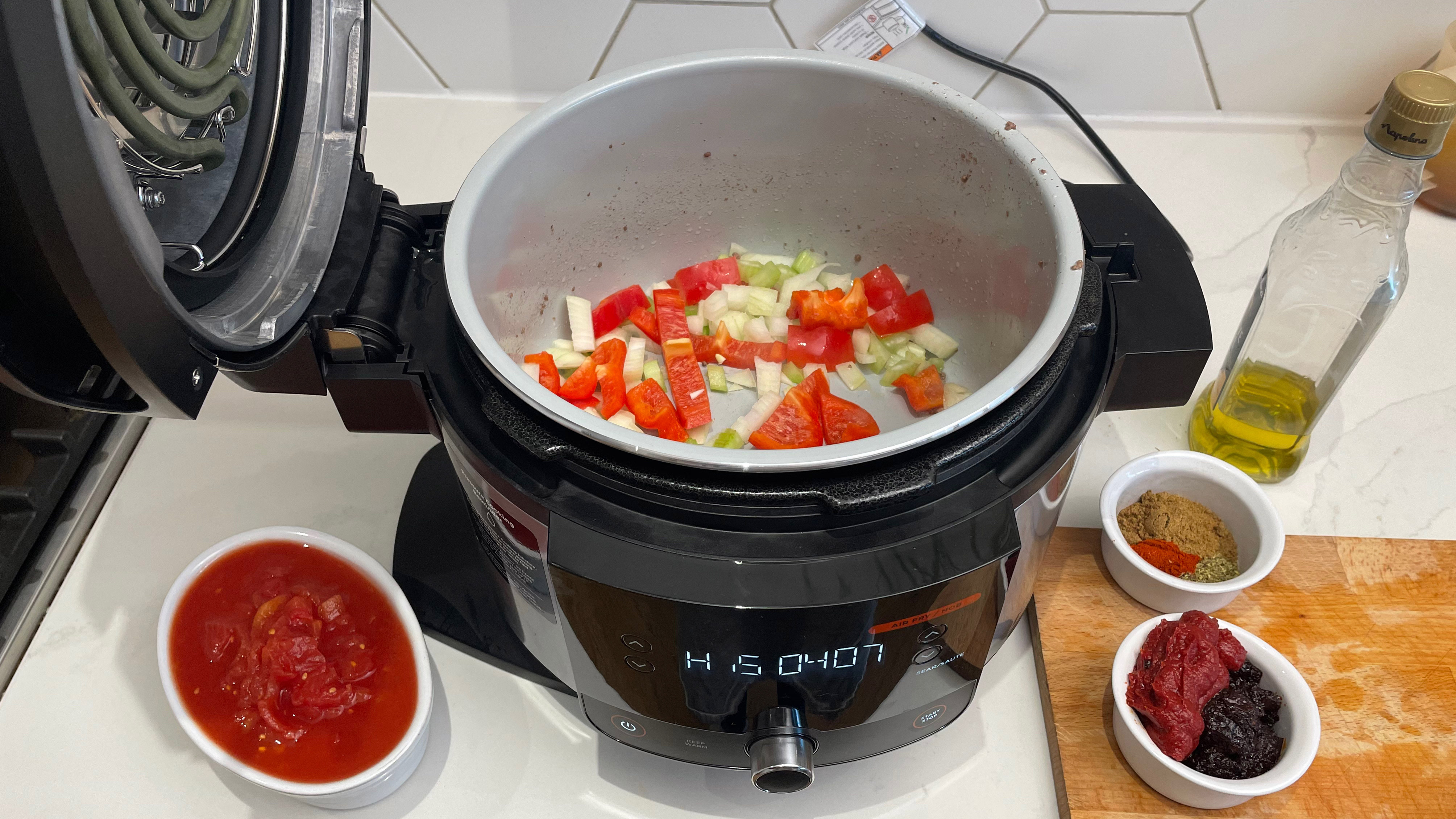 Tumis bawang bombay dan paprika di multi-cooker SmartLid Ninja Foodi 11-in-1 siap memasak cabai