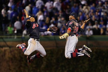 Francisco Lindor #12 and Rajai Davis #20 of the Cleveland Indians celebrate after defeating the Chicago Cubs 1-0 in Game Three