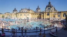 The outdoor pool filled with bathers at Szechenyi Bath in Budapest