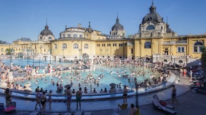 The outdoor pool filled with bathers at Szechenyi Bath in Budapest