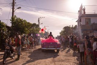 Neighbors gather to celebrate a quinceañera in the outskirts of Havana. Cuba. 2018.