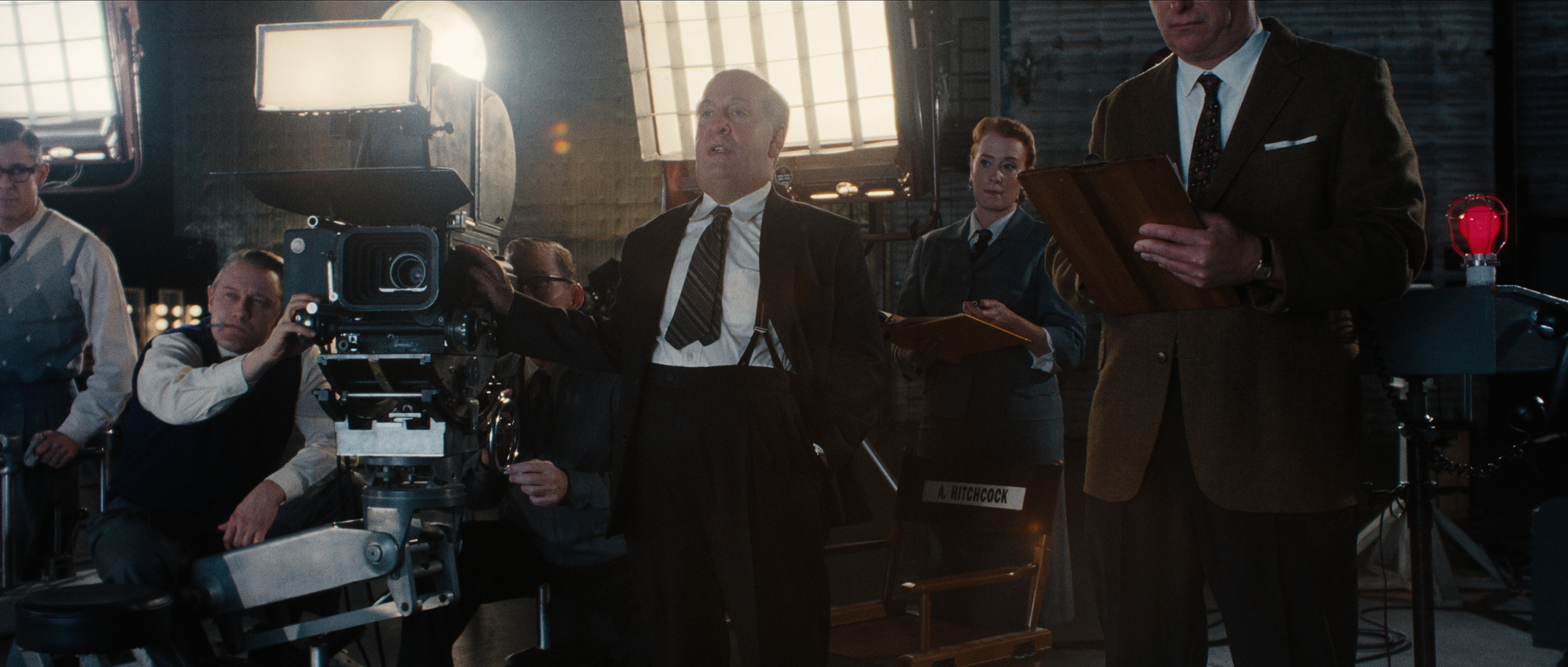 Tom Hollander as Alfred Hitchcock working on a movie set in a still from monster the ed gein story