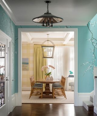 Blue hallway with handpainted wallpaper in a light filled 1930s home with clever use of pattern