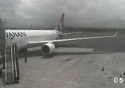 Airport surveillance camera captures stowaway teen stumbling around plane after landing