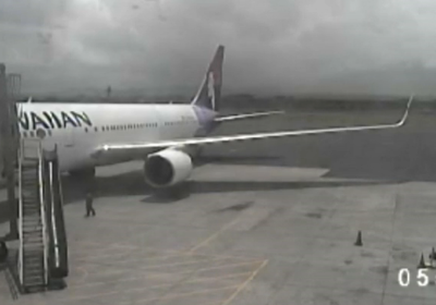 Airport surveillance camera captures stowaway teen stumbling around plane after landing