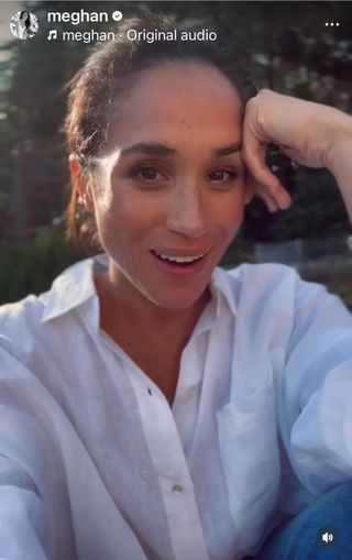 A photo of Meghan Markle wearing a white linen button-down shirt in a clip shared to Instagram.