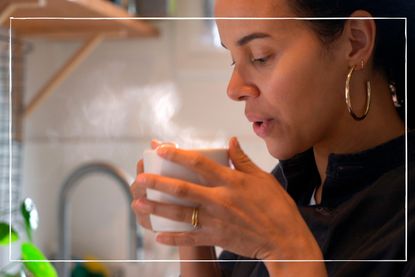 Close up of woman drinking a hot drink from a mug