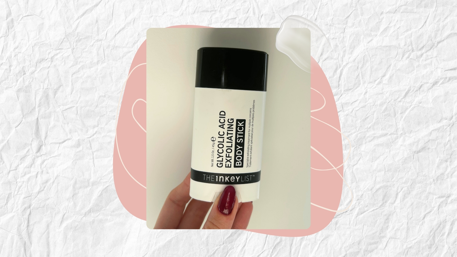 Image of hand holding The INKEY List Glycolic Acid Exfoliating Body Stick on a white textured background with a pink graphics