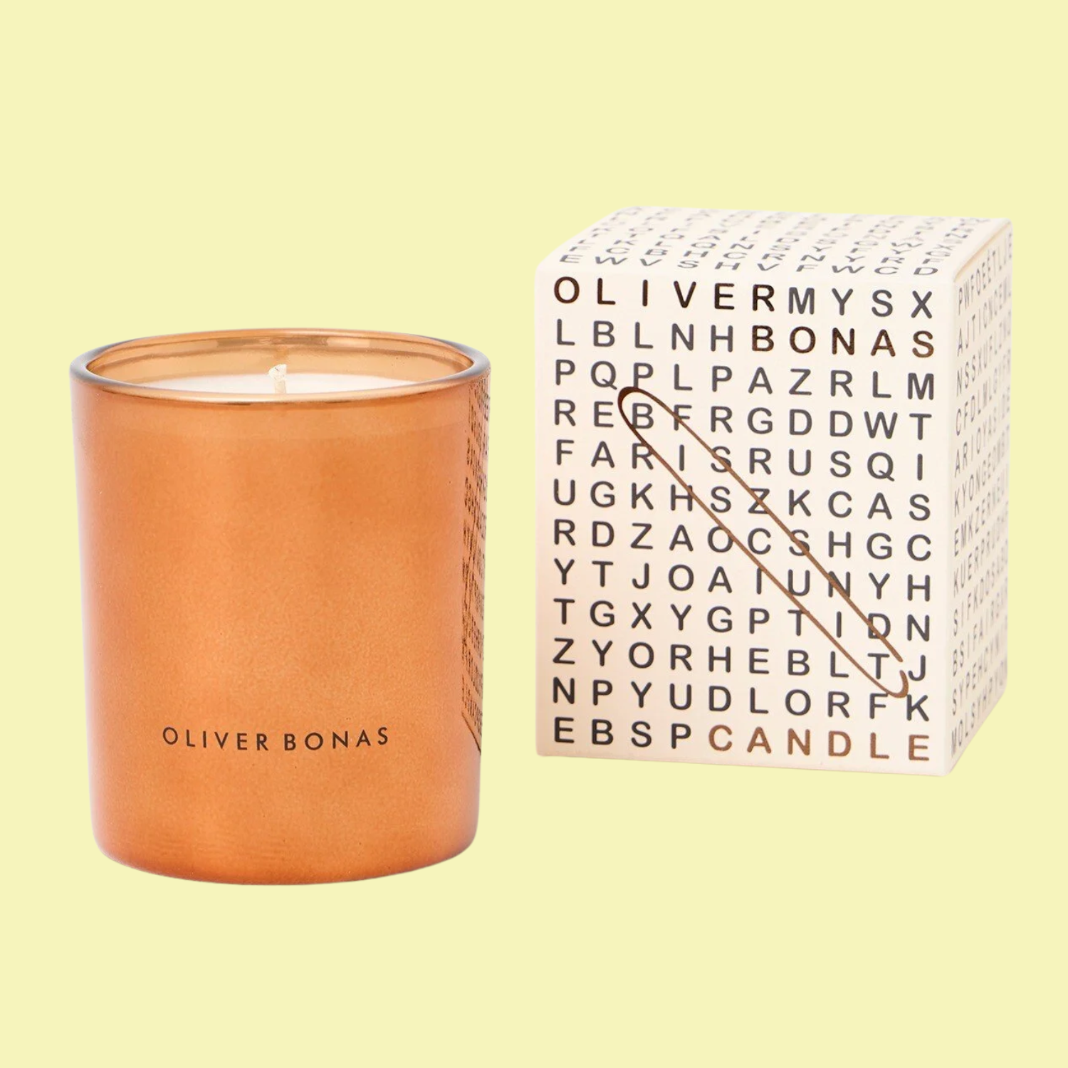 A scented candle in an orange glass