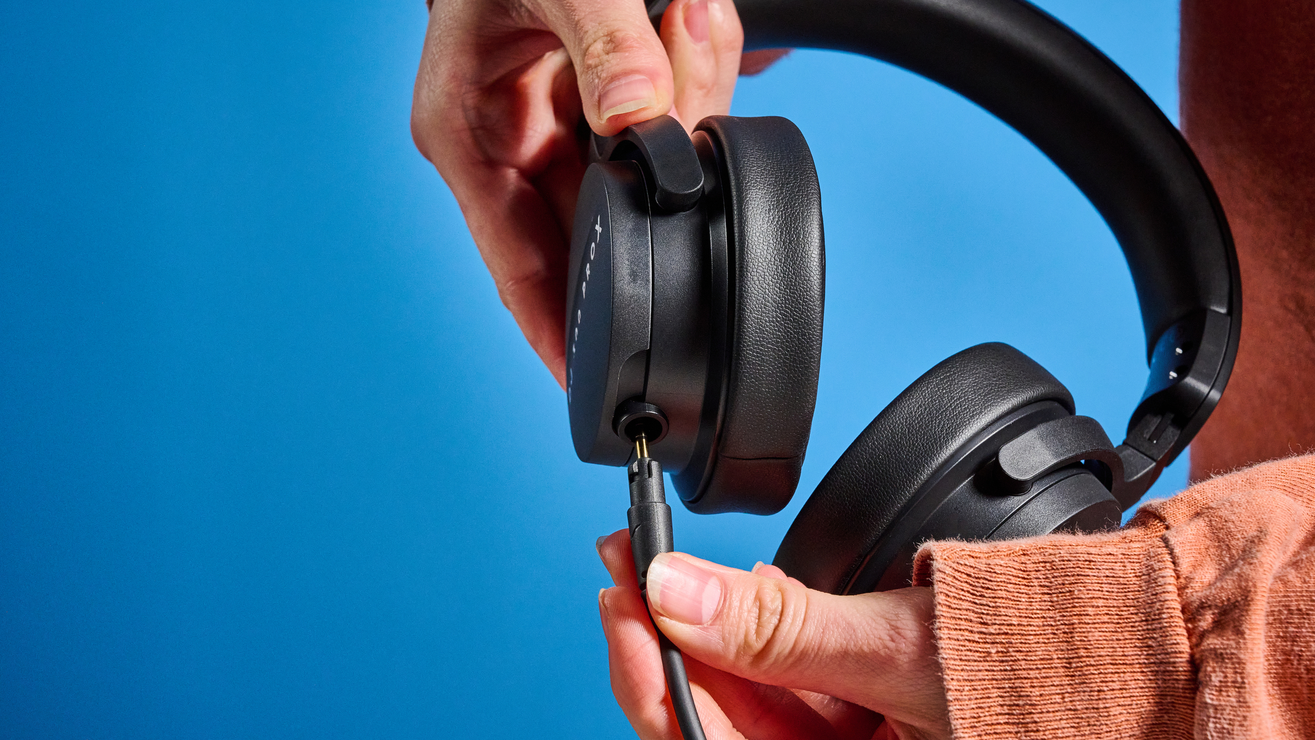 the beyerdynamic DJ 300 Pro X headphones in black showing their ear cups, carry bag, and connectivity options photographed against the blue tom's guide background