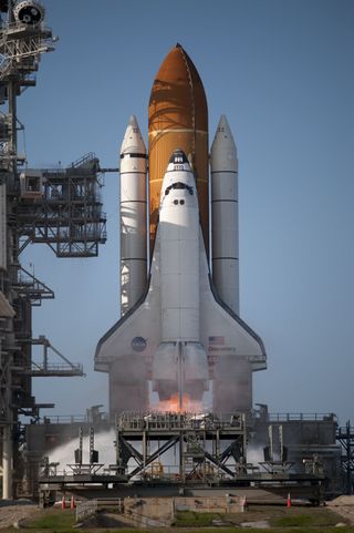 A tiny flicker of flame emerges as Space shuttle Discovery ignites for liftoff from Launch Pad 39A at NASA's Kennedy Space Center in Florida, beginning its final flight, the STS-133 mission, on Feb. 24, 2011.