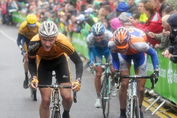 Mark McNally (Team Halfords) grimaces as he takes on St. Patrick&rsquo;s Hill one pedal stroke at a time.