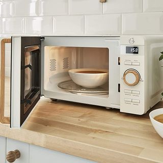 Swan Nordic Digital Microwave in white with door open showing a bowl of soup