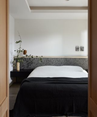 bedroom with black cover and gray headboard shelf