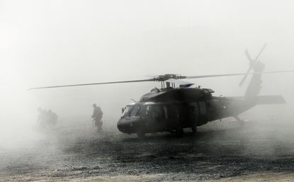 Troops disembark a helicopter in Afghanistan, 2009.